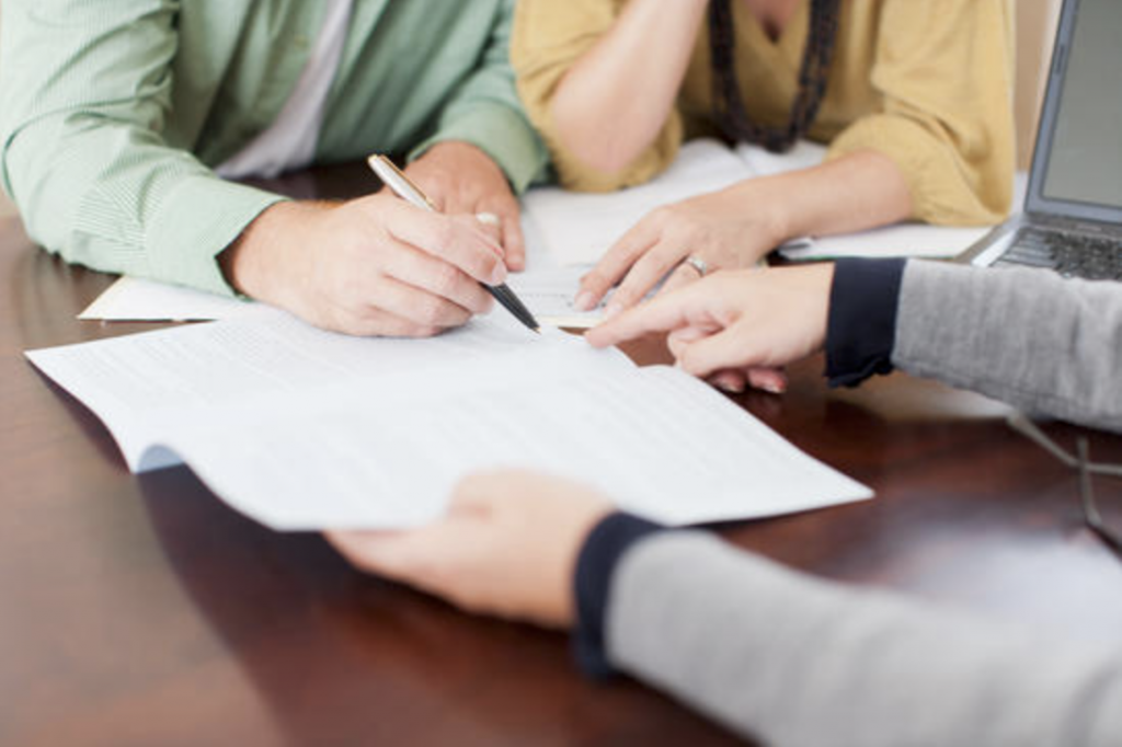 This photo depicts a contracting situation where both parties have agreed upon the clauses and conditions prior to signing.